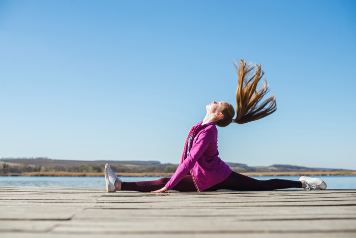 A girl is stretching outdoor 20-Minute Full-Body Workout