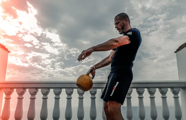 A person is performing Kettlebell Swings complete body exercise