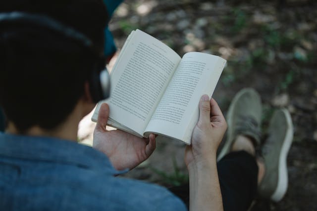Someone enjoying nature or analog hobbies like reading health and wellness