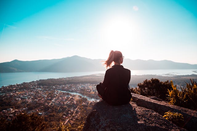 A women set on mountain peaceful place health and wellness