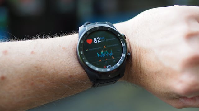 A close-up of a smartwatch or fitness tracker displaying heart rate data heart rate health