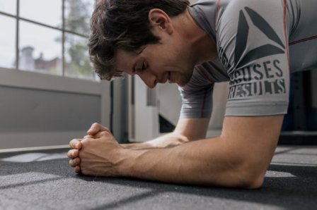 A person doing push-ups with proper form entire body workout