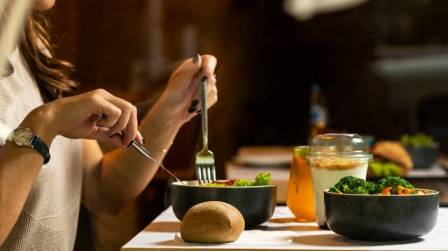  A person eating a healthy meal or holding a bowl of fresh food. diet healthy diet