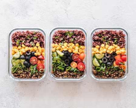 A simple image of meal prep containers with rice, vegetables, and proteins diet healthy diet