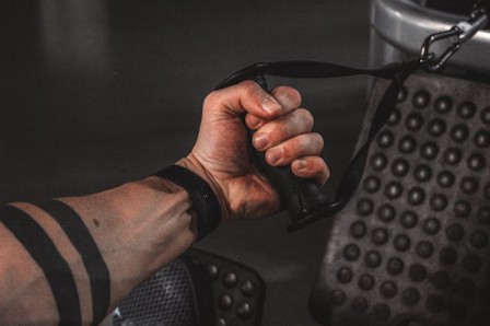 A fitness enthusiast performing drop sets on a cable machine gym workout