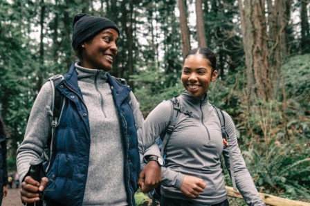 two women are walking and smiling Walking for fitness and weight loss