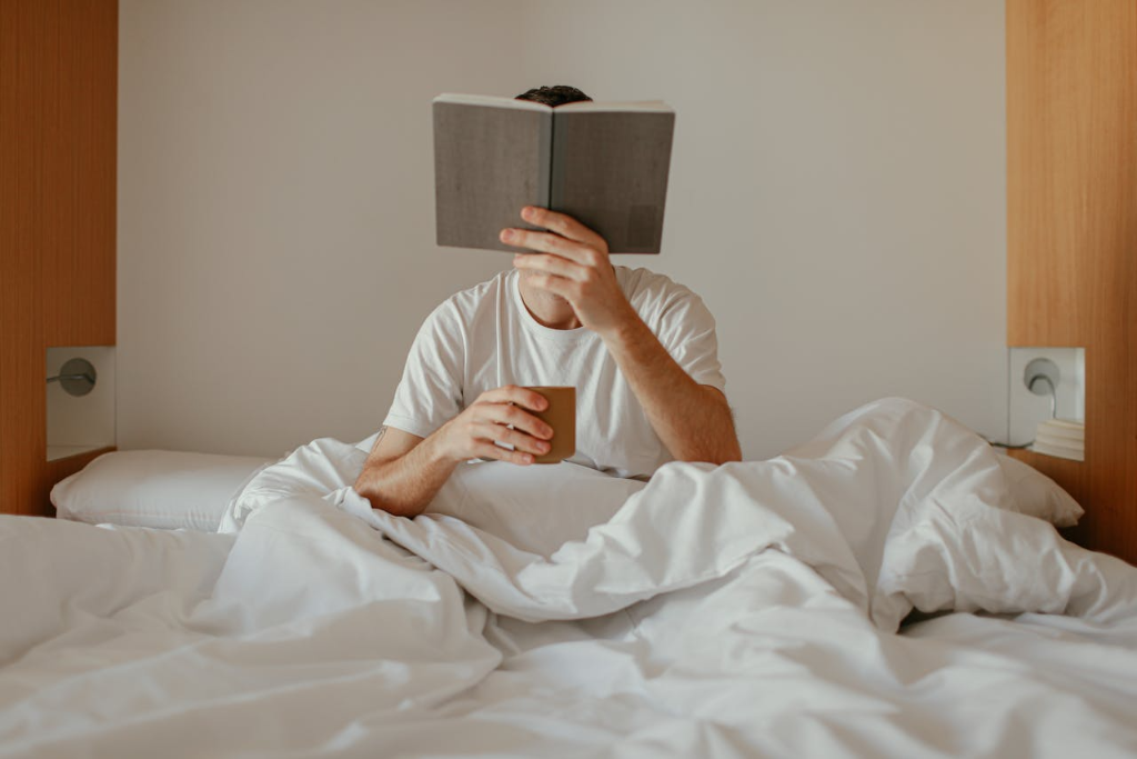 someone is reading book in bed Morning Habits